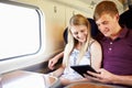 Young Couple Reading A Book On Train Journey Royalty Free Stock Photo