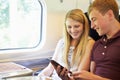 Young Couple Reading A Book On Train Journey Royalty Free Stock Photo