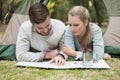 Young couple reading map in tent Royalty Free Stock Photo