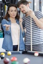 young couple receiving advice on shooting pool ball Royalty Free Stock Photo