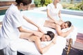 Young couple receiving a back massage from masseur Royalty Free Stock Photo