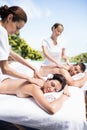 Young couple receiving a back massage from masseur