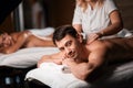 Young couple receiving a back massage in a Spa center Royalty Free Stock Photo