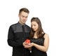 Young couple with red heart in hands