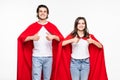 Young couple man and woman in red hero look hugging showing thumbup isolated on white background