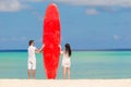 Young couple with red surfboard during tropical vacation Royalty Free Stock Photo