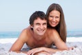 Young Couple Relaxing On Beach Wearing Swimwear Royalty Free Stock Photo