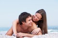Young Couple Relaxing On Beach Wearing Swimwear Royalty Free Stock Photo