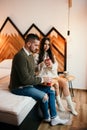 Young couple relaxing in bed drinking coffee and enjoying a moment together Royalty Free Stock Photo