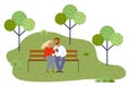 Young couple relaxing at bench in park, girl holding grape, feeding boyfriend with berries Royalty Free Stock Photo