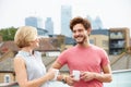 Young Couple Relaxing With Coffee On Roof Terrace