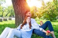 Young couple relaxing with coffee under tree Royalty Free Stock Photo