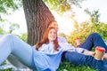 Young couple relaxing with coffee under tree Royalty Free Stock Photo