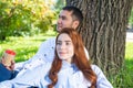 Young couple relaxing with coffee under tree Royalty Free Stock Photo