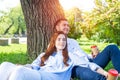 Young couple relaxing with coffee under tree Royalty Free Stock Photo