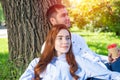 Young couple relaxing with coffee under tree Royalty Free Stock Photo