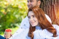 Young couple relaxing with coffee under tree Royalty Free Stock Photo