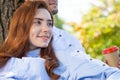 Young couple relaxing with coffee under tree Royalty Free Stock Photo