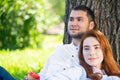 Young couple relaxing with coffee under tree Royalty Free Stock Photo