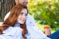 Young couple relaxing with coffee under tree Royalty Free Stock Photo