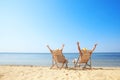 Young couple relaxing in deck chairs Royalty Free Stock Photo