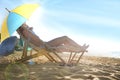 Young couple relaxing in deck chairs under umbrella for sun protection on beach Royalty Free Stock Photo