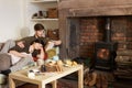 Young couple relaxing by fire Royalty Free Stock Photo