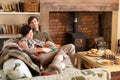 Young couple relaxing by fire Royalty Free Stock Photo