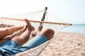 Young couple relaxing in hammock on beach Royalty Free Stock Photo