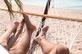 Young couple relaxing in hammock on beach Royalty Free Stock Photo