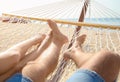 Young couple relaxing in hammock on beach Royalty Free Stock Photo