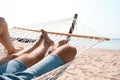 Young couple relaxing in hammock on beach Royalty Free Stock Photo