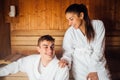 Young couple relaxing inside spa sauna room.Romantic newlyweds enjoying honeymoon vacation day doing body treatment in luxury Royalty Free Stock Photo