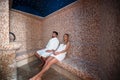 Young couple relaxing inside spa sauna turkish bath - Two lovers enjoying vacation in luxury resort hotel Royalty Free Stock Photo