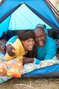Young Couple Relaxing Inside Tent On Holiday Royalty Free Stock Photo