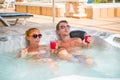 Young couple relaxing in jacuzzi pool