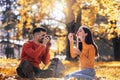 Couple relaxing in the park with bubble blower Royalty Free Stock Photo