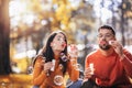 Couple relaxing in the park with bubble blower Royalty Free Stock Photo