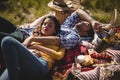 Young couple relaxing on picnic blanket at olive farm Royalty Free Stock Photo