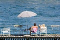 Young couple relaxing on the river pier