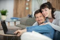 young couple relaxing sitting on sofa using computer Royalty Free Stock Photo