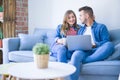 Young couple relaxing sitting on the sofa using the computer laptop Royalty Free Stock Photo