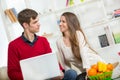 Young couple relaxing on sofa with laptop in the living room. Royalty Free Stock Photo
