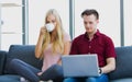 Young couple relaxing on sofa with laptop Royalty Free Stock Photo