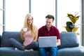 Young couple relaxing on sofa with laptop Royalty Free Stock Photo