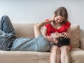 Young couple is relaxing on sofa and touching. Love concept