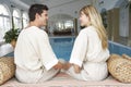 Young Couple Relaxing By Swimming Pool Royalty Free Stock Photo