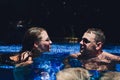 Young couple are relaxing at swimming pool party. Summer vacation concept. Royalty Free Stock Photo