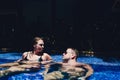 Young couple are relaxing at swimming pool party. Summer vacation concept. Royalty Free Stock Photo