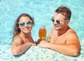 Young couple are relaxing in swimming pool Royalty Free Stock Photo